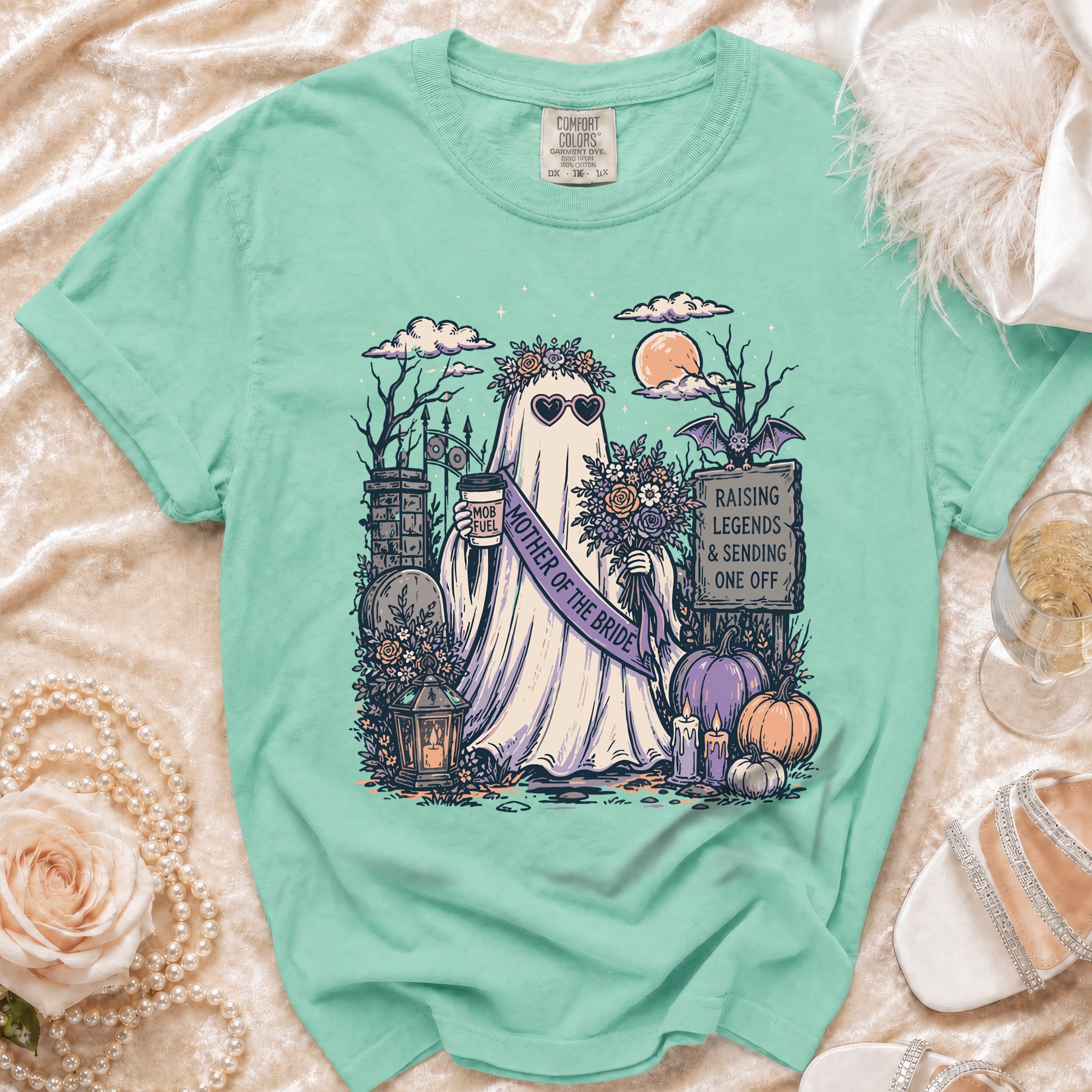 Ghost with "Mother of the Bride" sash holds coffee and flowers, "Raising Legends" sign.