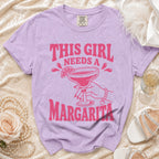 Lavender t-shirt with "THIS GIRL NEEDS A MARGARITA" graphic.