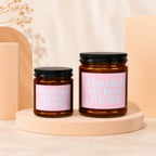 Two amber glass candles with pink labels reading "Married my best friend."