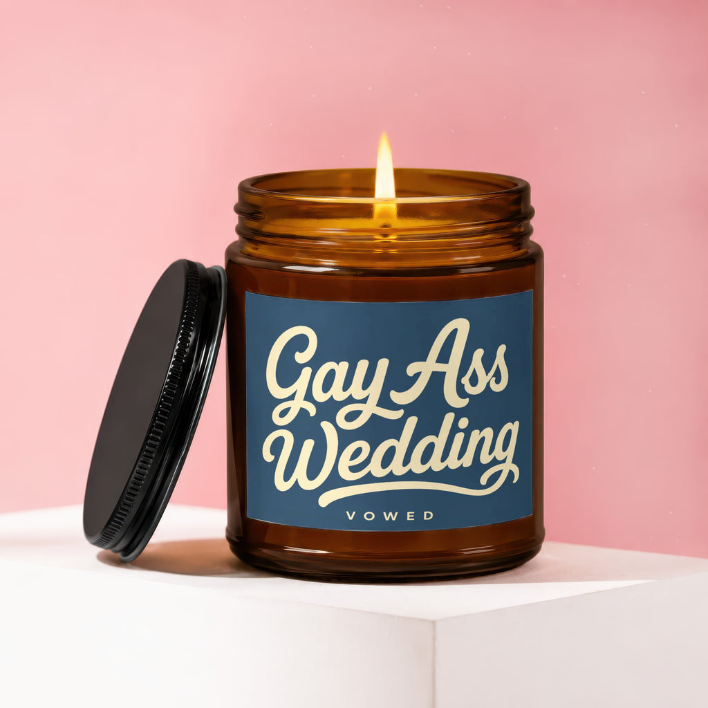 Amber glass candle with lit wick and "Gay Ass Wedding Vowed" label.