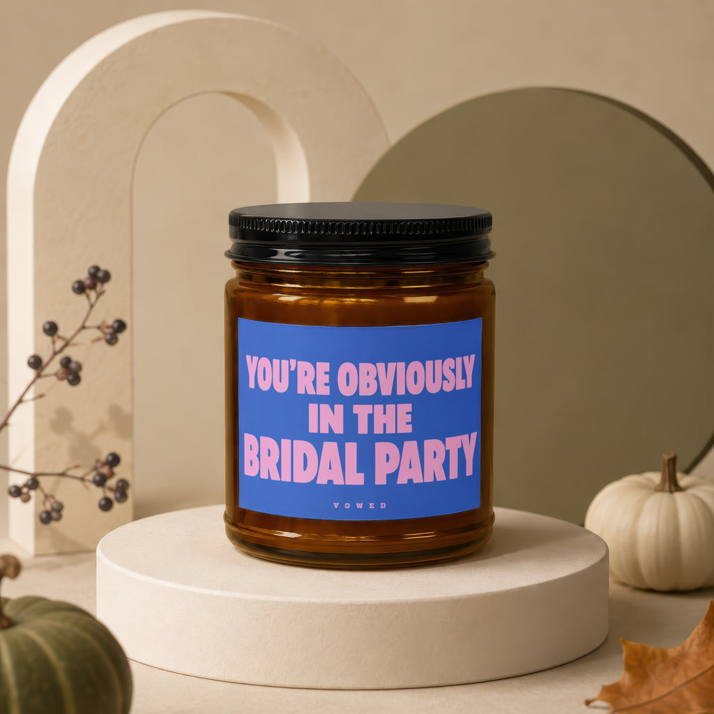 Candle with text "YOU'RE OBVIOUSLY IN THE BRIDAL PARTY" on blue label.