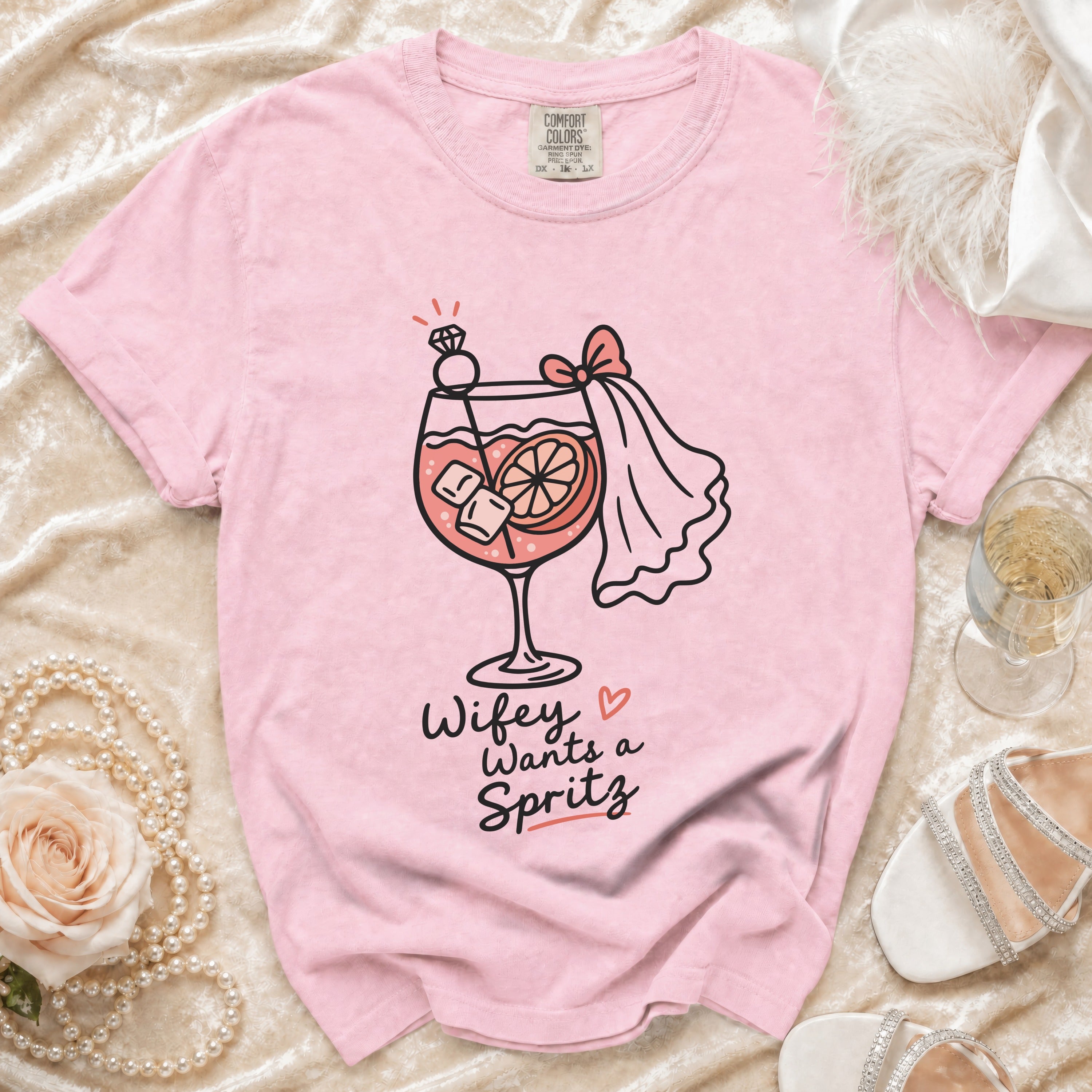 Pink t-shirt with "Wifey Wants a Spritz" graphic on a cocktail glass.