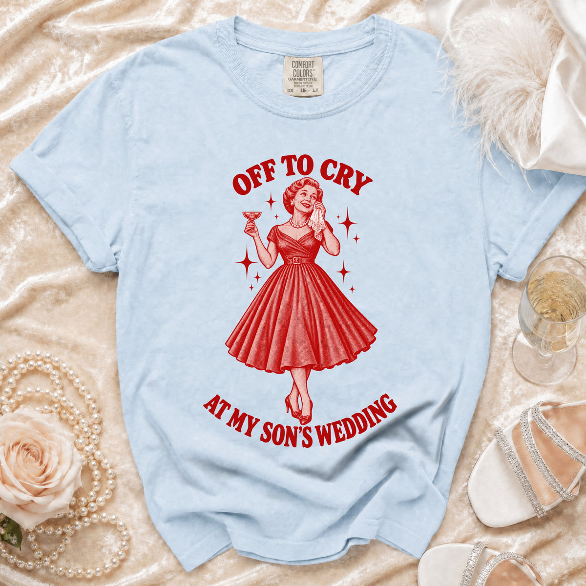 Light blue t-shirt with "Off to cry at my son's wedding" graphic.
