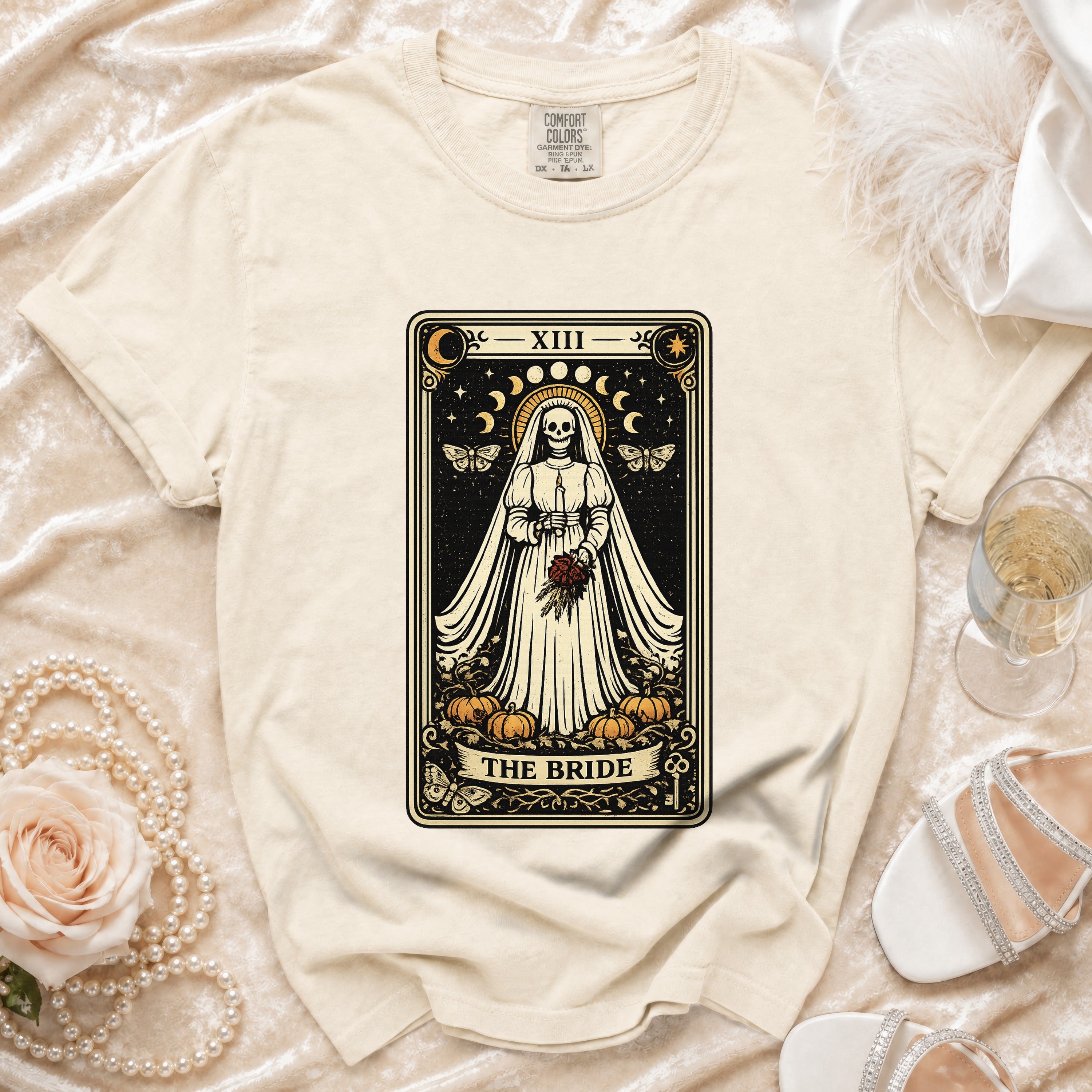 Cream t-shirt with tarot card design of skeleton bride captioned "THE BRIDE."