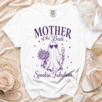 White t-shirt with purple text and ghost graphic reading "Mother of the Bride Spookin' Fabulous".