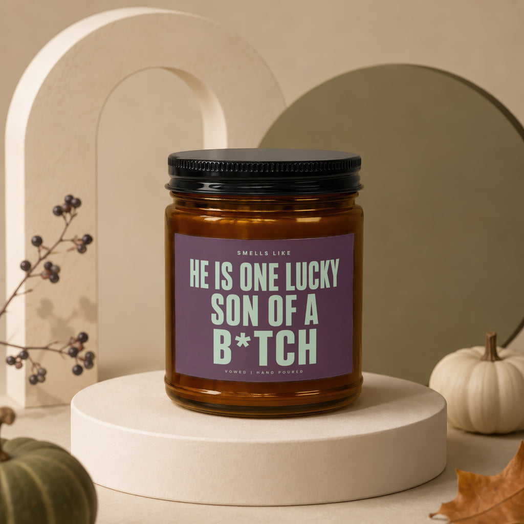 Amber jar candle with "He is one lucky son of a b*tch" text.