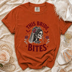 Orange t-shirt with skeleton bride graphic saying "THIS BRIDE BITES".
