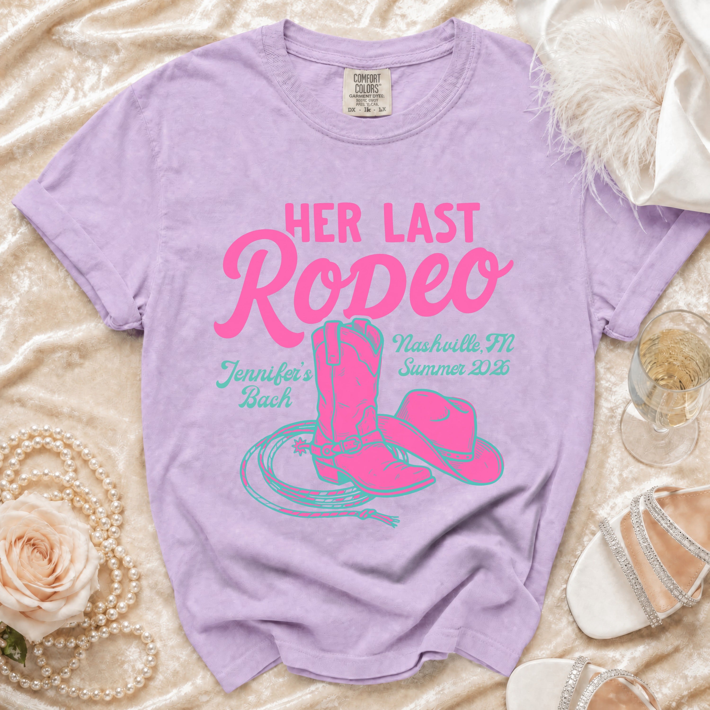 Purple t-shirt with "Her Last Rodeo" text, cowboy boots, hat, and lasso graphic.