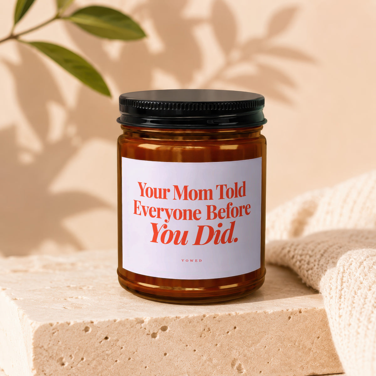 Amber candle with black lid reads "Your Mom Told Everyone Before You Did."