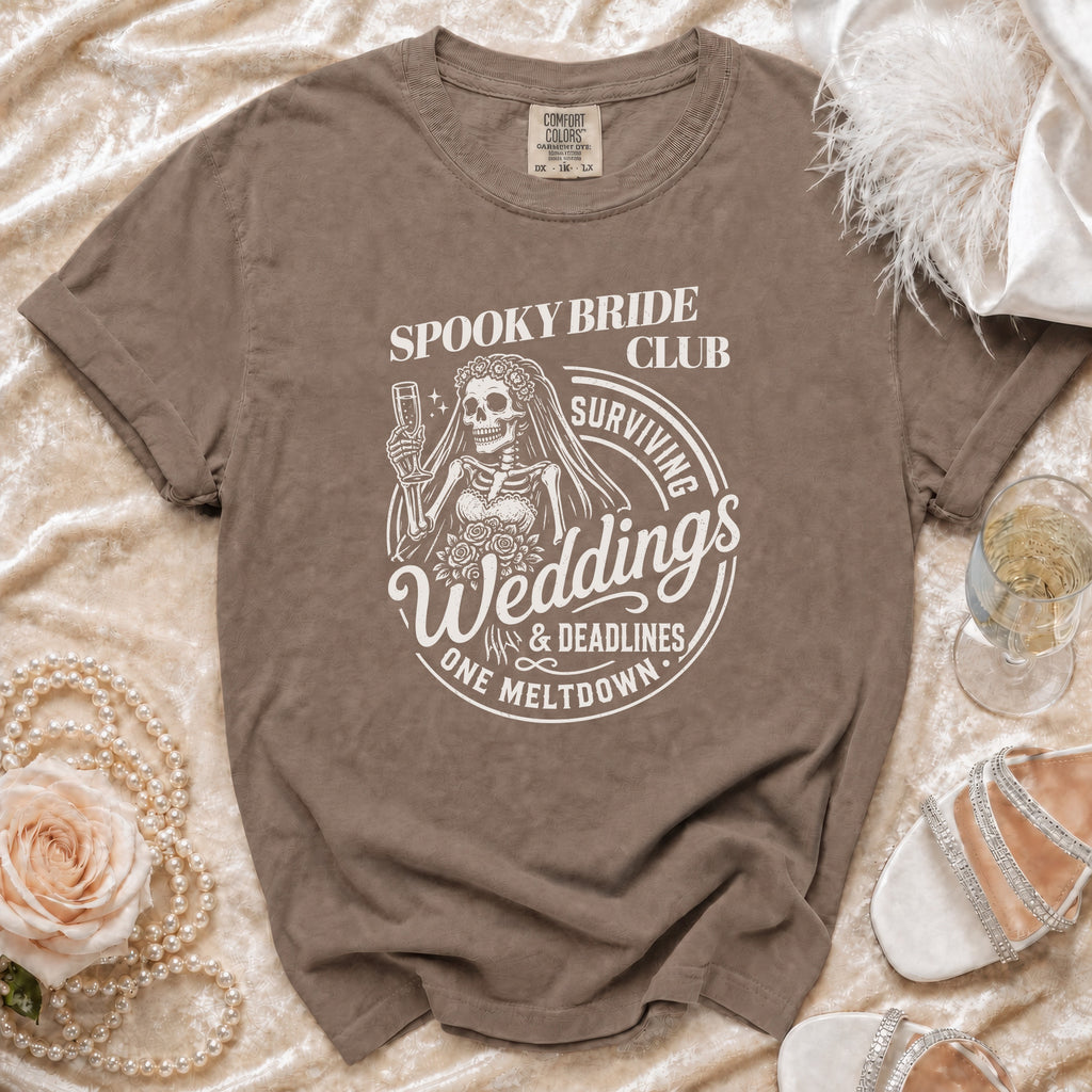 Brown t-shirt with "Spooky Bride Club Surviving Weddings & Deadlines One Meltdown" graphic.