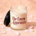 Candle with label "Smells like The Coven Approves".