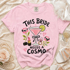 Pink t-shirt with "This Bride Needs a Cosmo" graphic and martini glass.