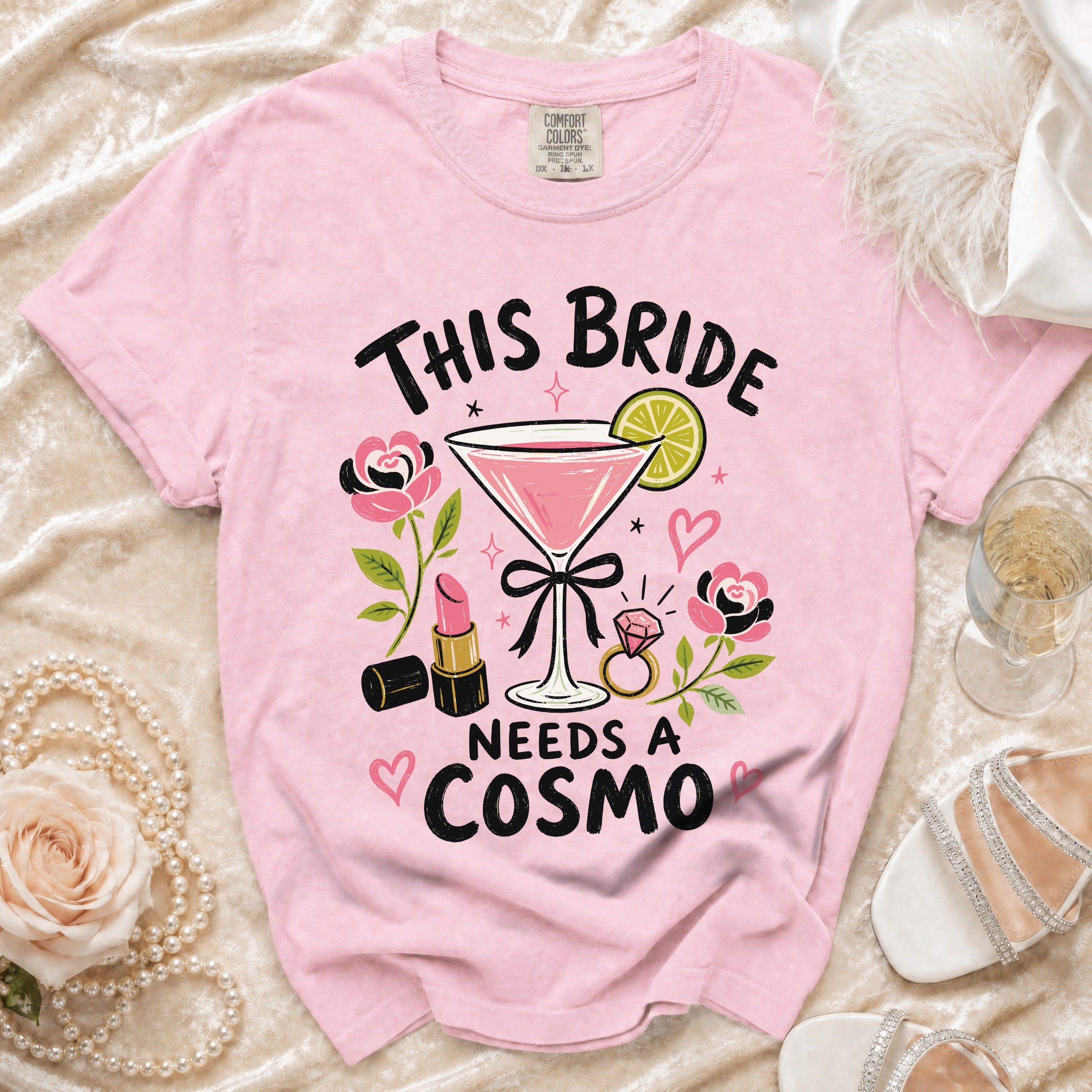 Pink t-shirt with "This Bride Needs a Cosmo" graphic and martini glass.