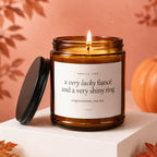 Amber jar candle with "a very lucky fiancé and a very shiny ring" text.