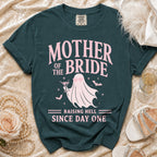 Teal t-shirt with "Mother of the Bride Raising Hell Since Day One" text and a ghost graphic.