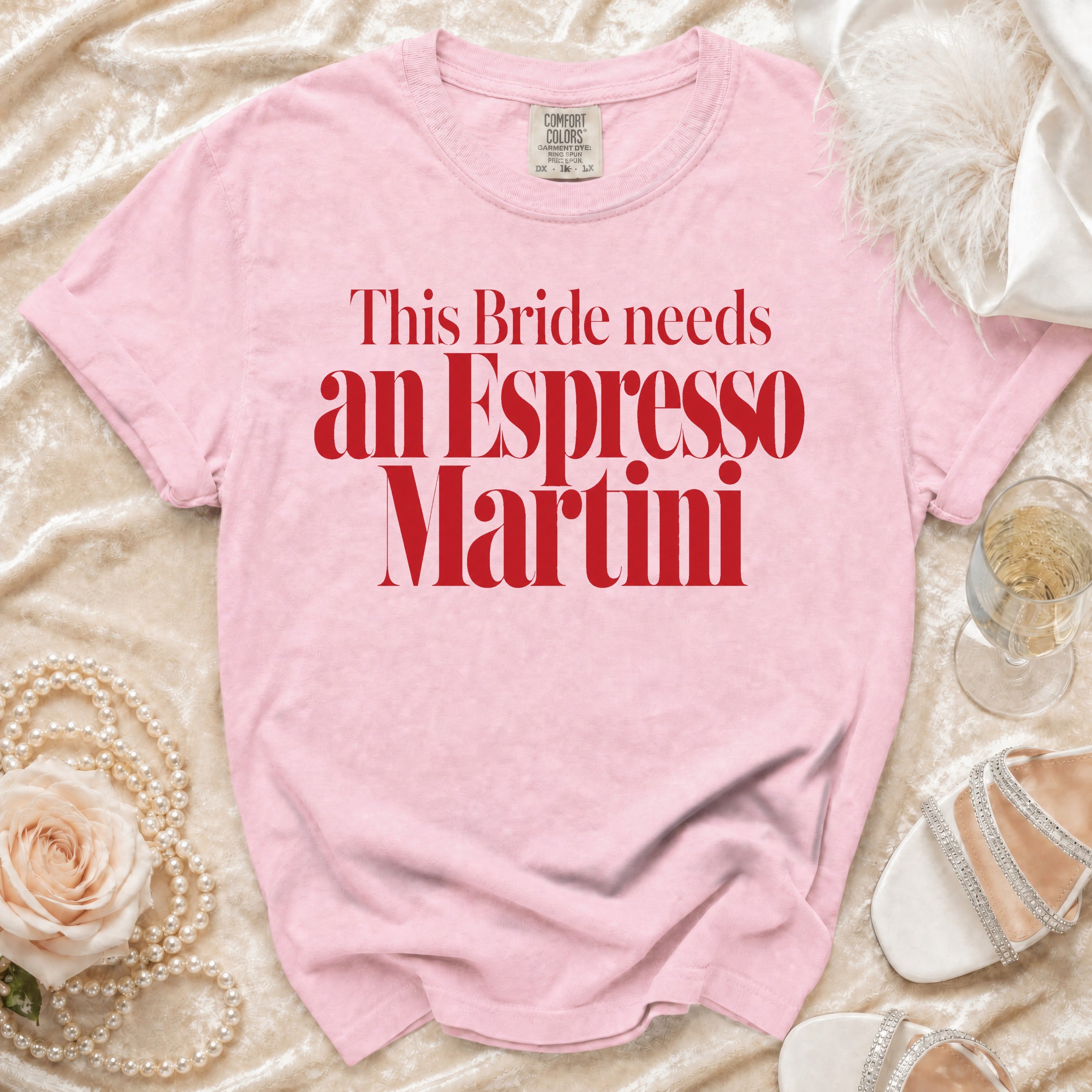 Pink t-shirt with "This Bride needs an Espresso Martini" text and champagne accessories.