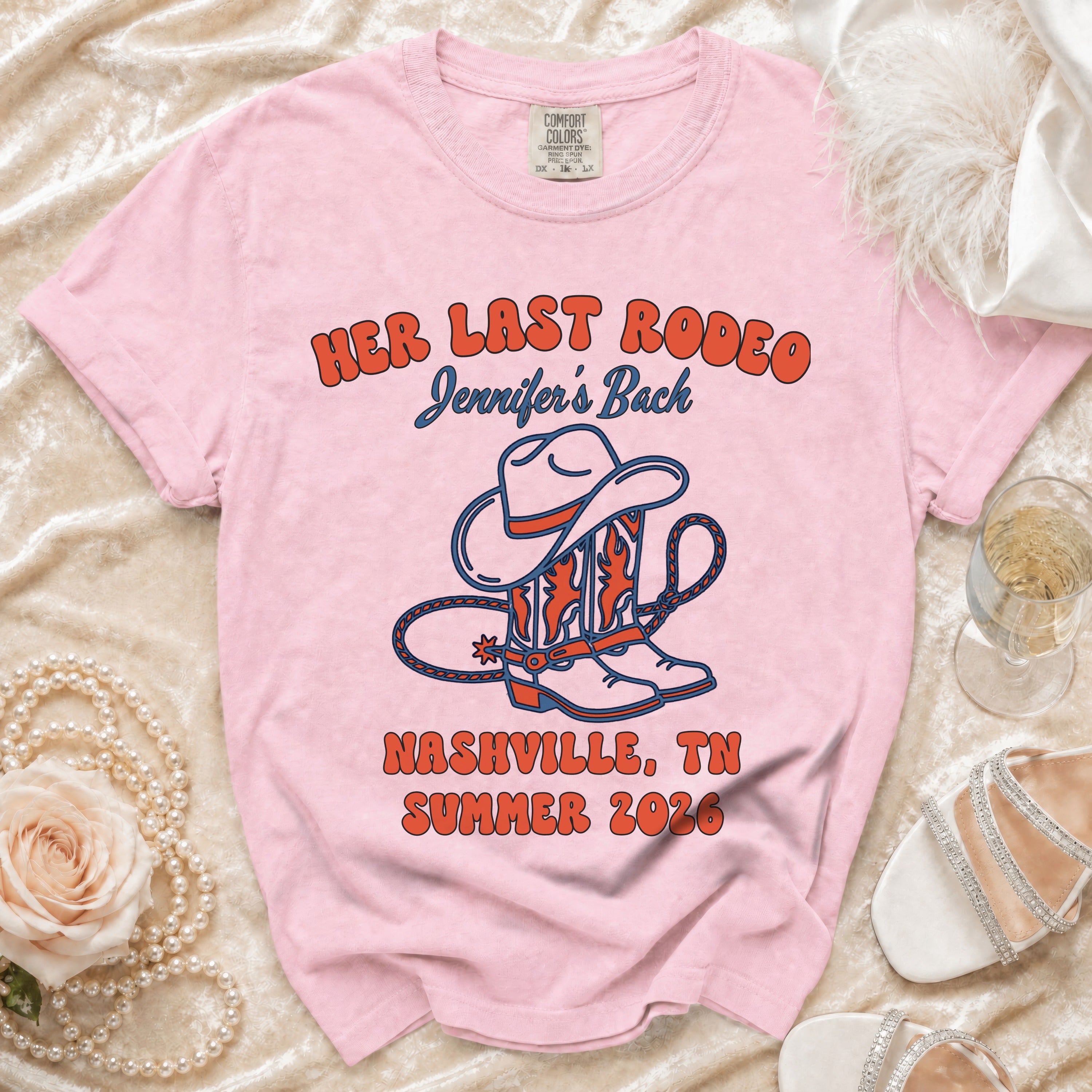 Pink t-shirt with "Her Last Rodeo Nashville, TN Summer 2026" text and cowboy boots.