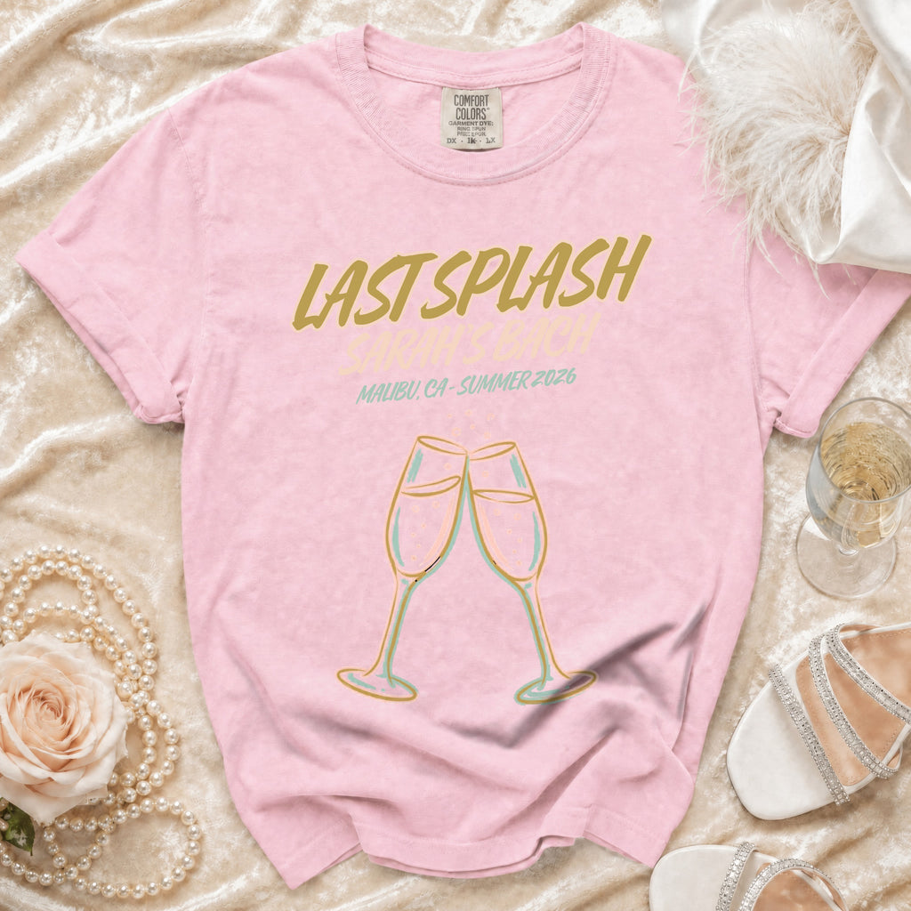 Pink t-shirt with "Last Splash Malibu, CA-Summer 2026" and champagne glasses.