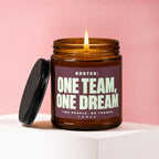 Amber jar candle with lit flame and text "ROSTER: ONE TEAM, ONE DREAM. TWO PEOPLE. NO TRADES. VOWED."