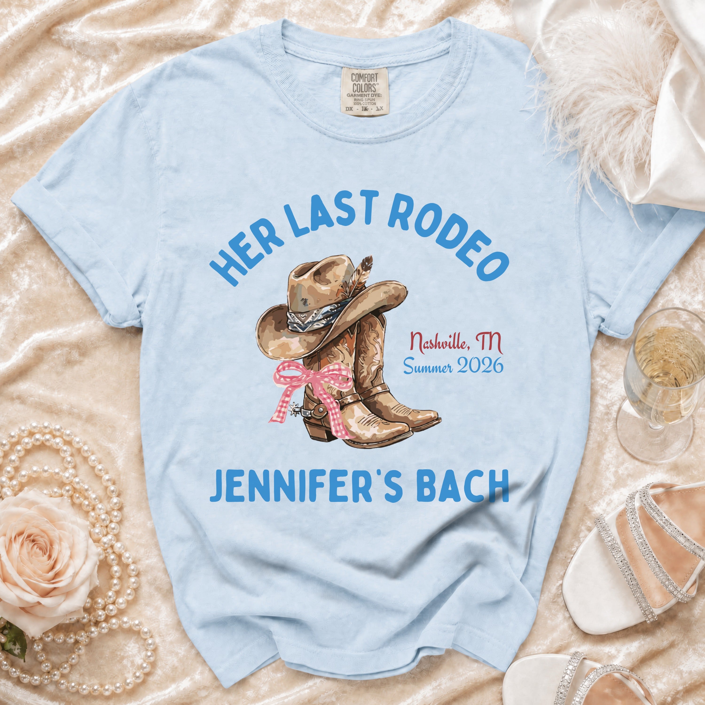 Light blue t-shirt with "Her Last Rodeo" and "Jennifer's Bach" text and cowboy boot graphic.