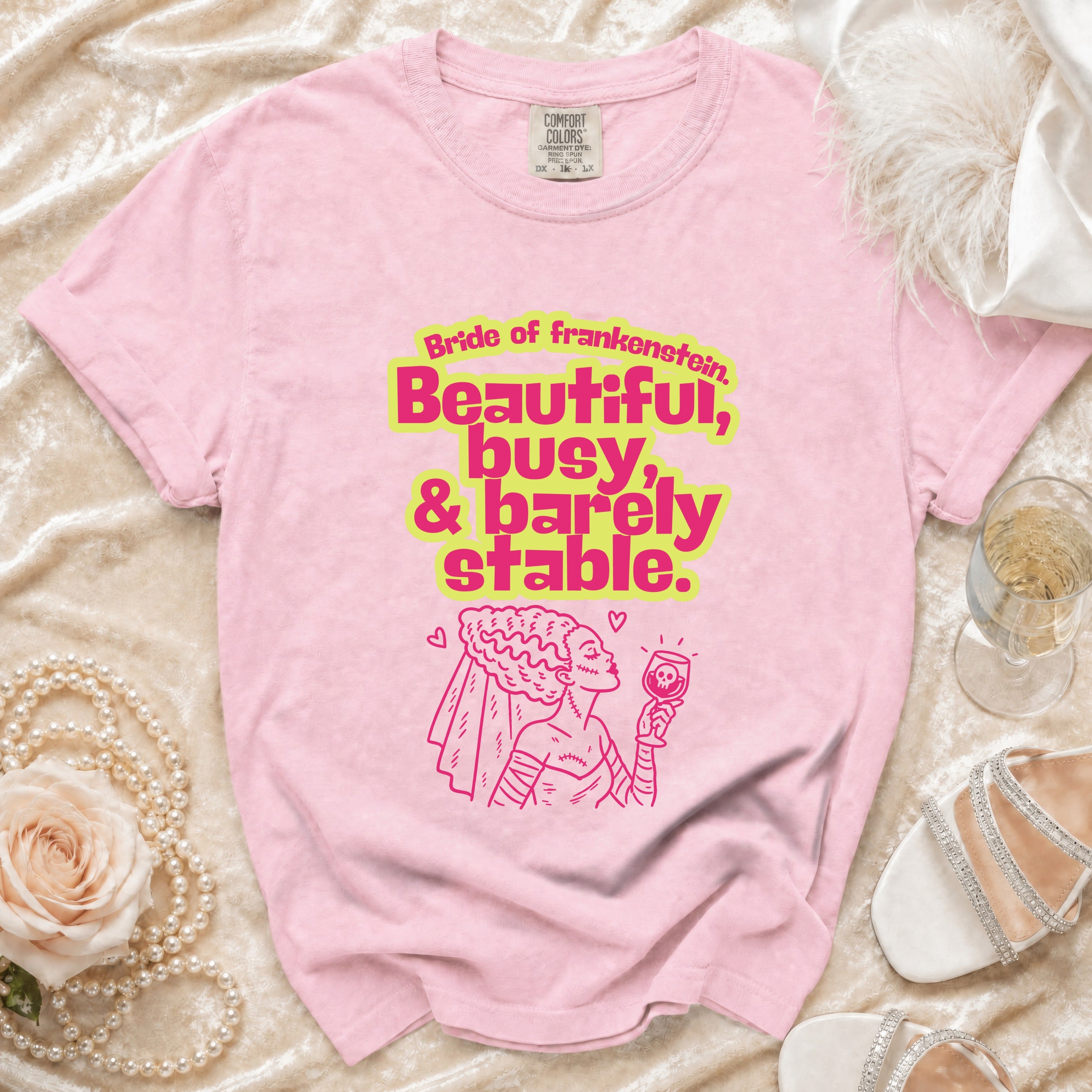 Pink t-shirt with "Bride of Frankenstein, Beautiful, busy, & barely stable." text and graphic.