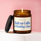 Amber jar candle with lit flame, reading "Built on Coffee & Wedding Chaos."