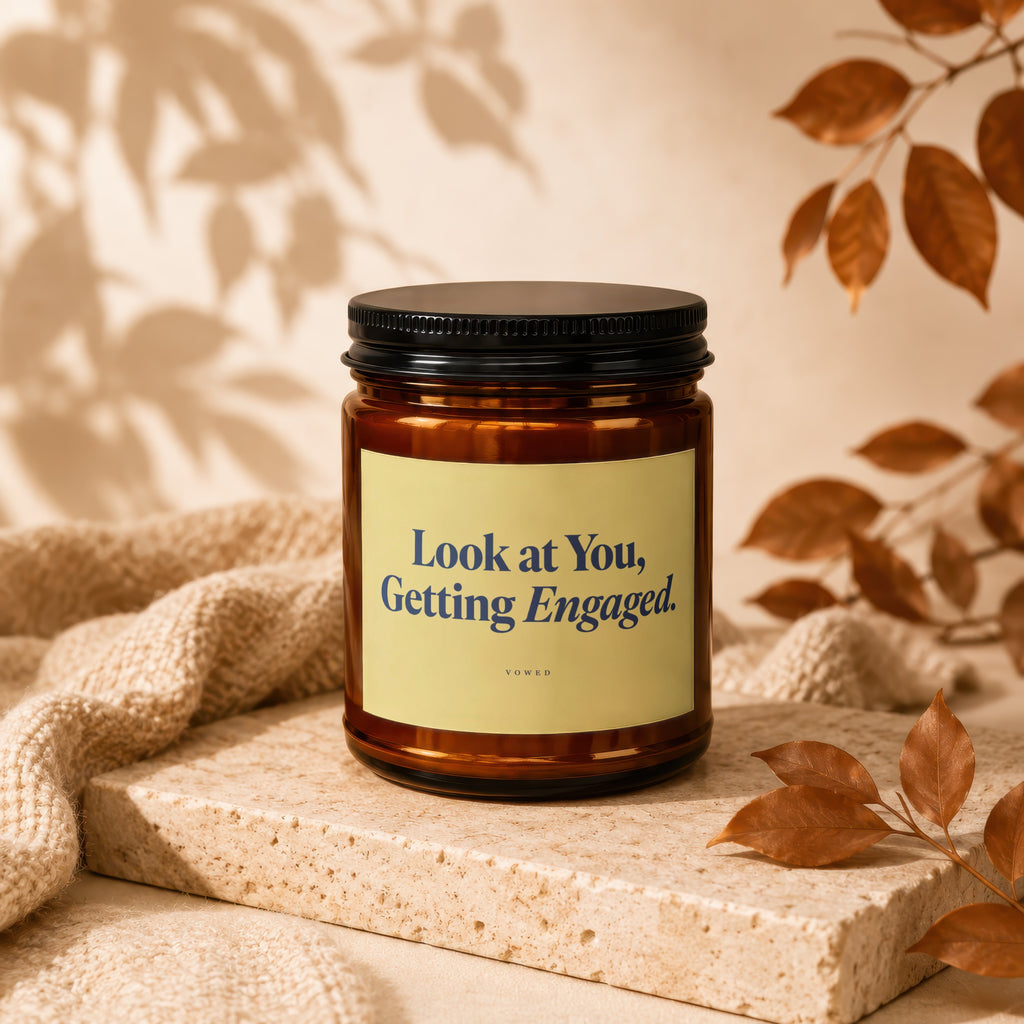 Brown candle with black lid, yellow label reading "Look at You, Getting Engaged."