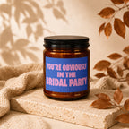 Amber candle with "You're Obviously In The Bridal Party" text on a blue label.