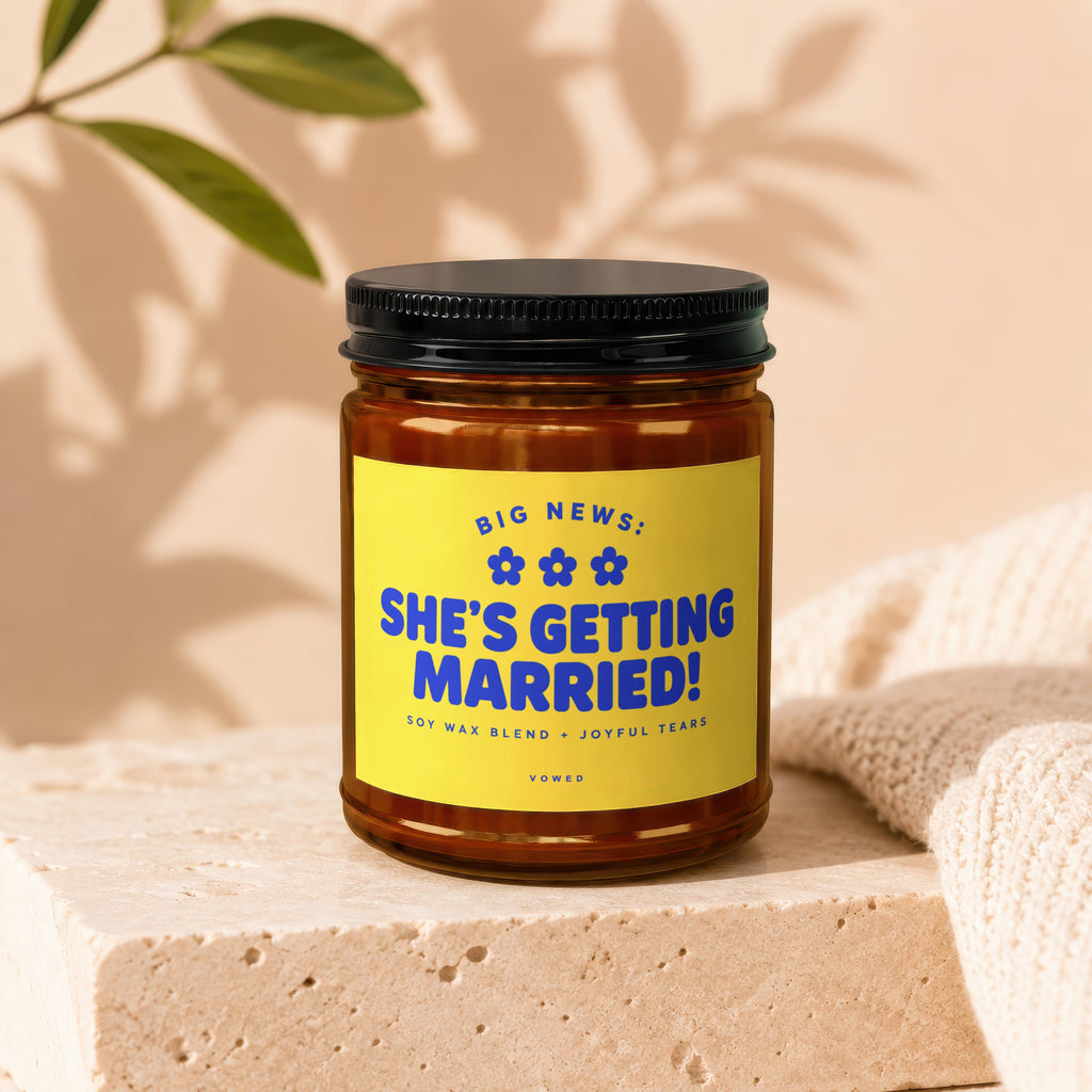 Candle with yellow label reading "Big News: She's Getting Married!".