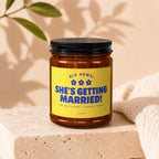 Candle with yellow label reading "Big News: She's Getting Married!".