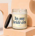 Glass jar candle with black lid, featuring text "In my bride era." and "VOWED".