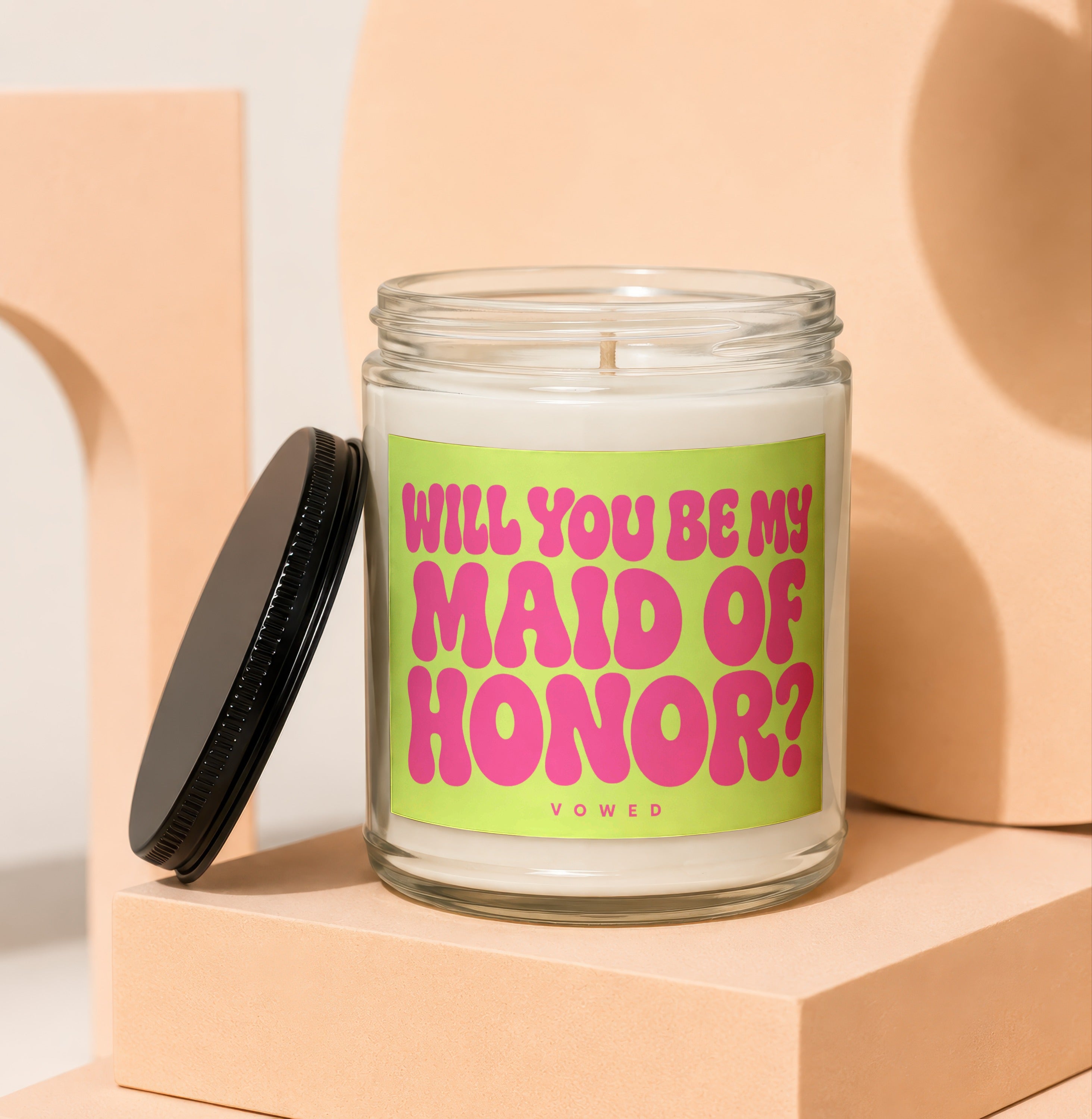 Glass candle with a lime green label asking "Will You Be My Maid of Honor?"