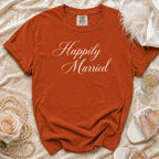 Orange t-shirt with "Happily Married" in white script, shown with pearls and heels.