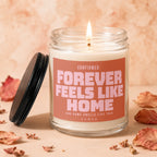 Candle with text "CONFIRMED: FOREVER FEELS LIKE HOME AND HOME SMELLS LIKE THIS VOWED".