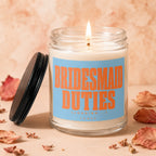 Lit candle in glass jar with orange text "BRIDESMAID DUTIES (LOADING...) VOWED".