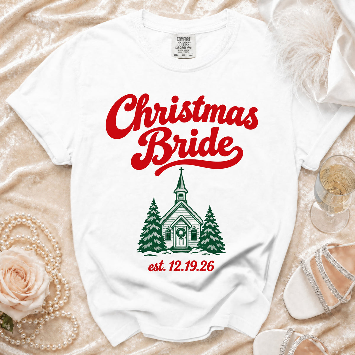 White t-shirt featuring red Christmas Bride text and a green church graphic with pine trees.