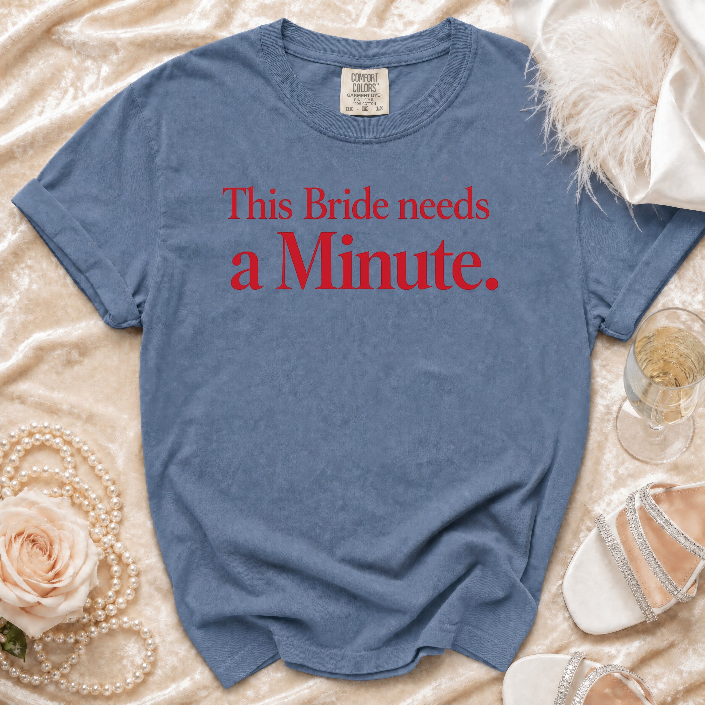 Blue t-shirt with red text "This Bride needs a Minute."
