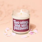 Lit candle in a jar with "Two wives, one wifi, password" text, surrounded by flower petals.