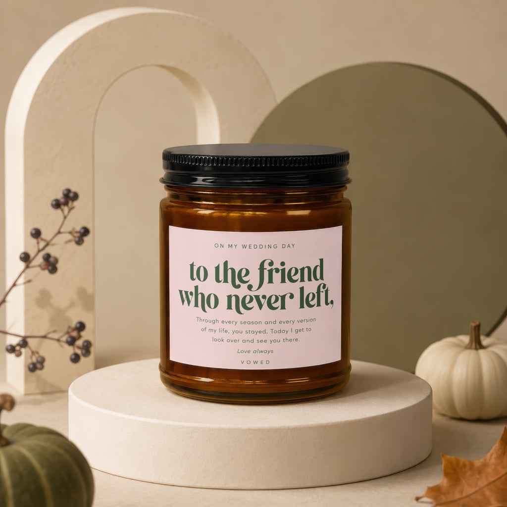 Amber jar candle with black lid and pink label reading "to the friend who never left."