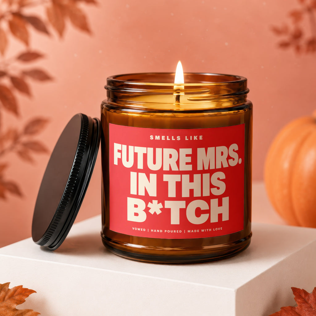 Amber candle with red label reading "Future Mrs. in this B*tch".