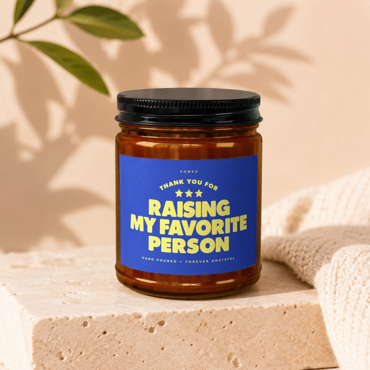Amber jar candle with black lid, reads "Thank You For Raising My Favorite Person".