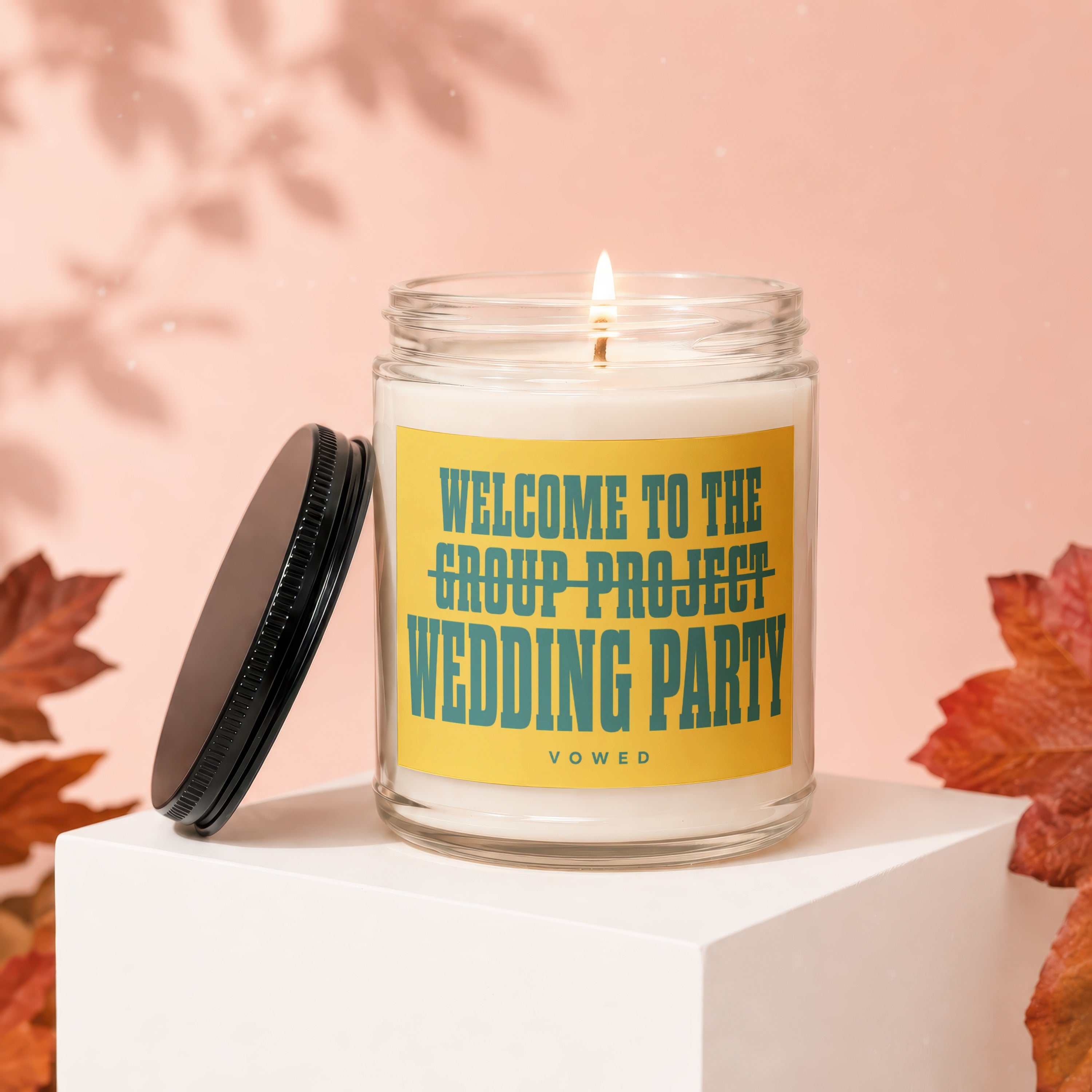 Candle with label reading "WELCOME TO THE GROUP PROJECT WEDDING PARTY VOWED".