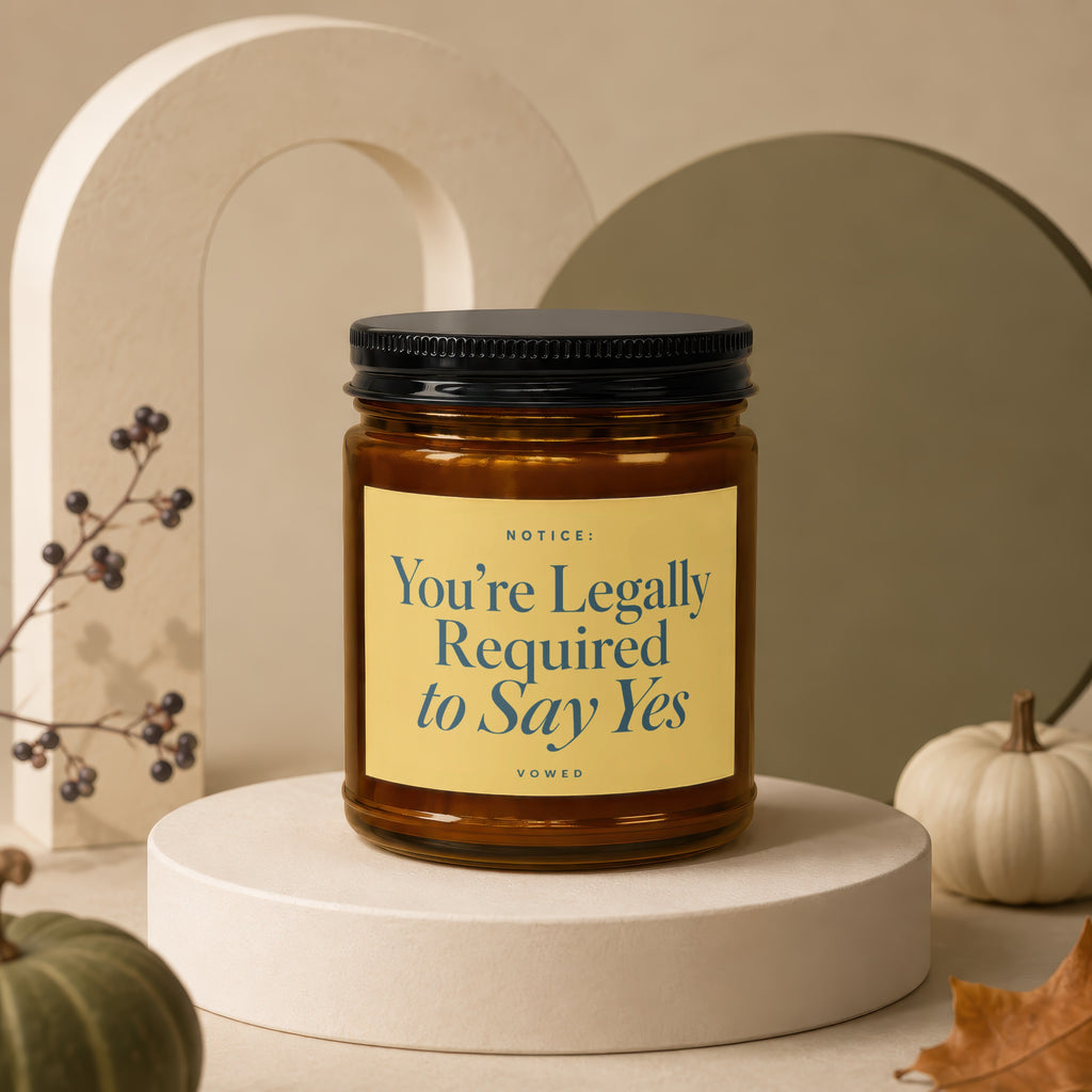 Candle with "You're Legally Required to Say Yes" text on a yellow label.