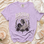 Purple t-shirt with "Bride After Dark" text and a skeleton bride with bouquet graphic.