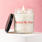 Jar candle with lit wick, label reads "Married My Person," "To the Happy Couple," "Vowed."
