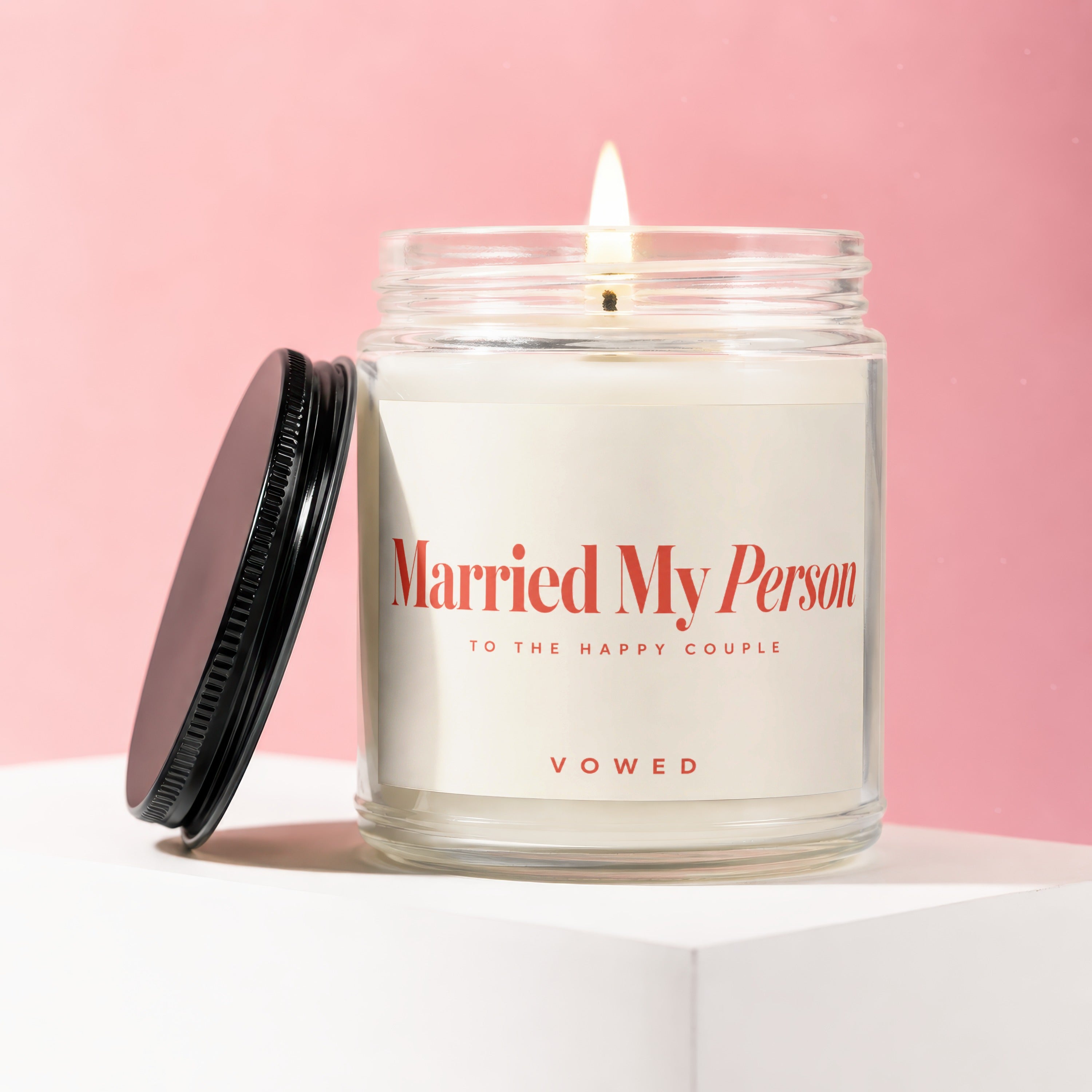 Jar candle with lit wick, label reads "Married My Person," "To the Happy Couple," "Vowed."
