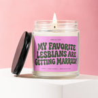 Glass jar candle with pink label reading "My Favorite Lesbians Are Getting Married!"