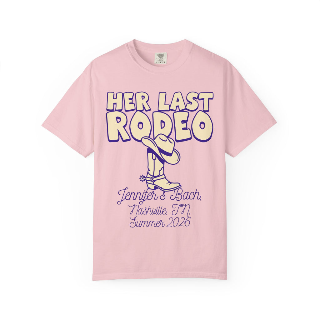 Pink t-shirt with "Her Last Rodeo" text, boot graphic, and event details.