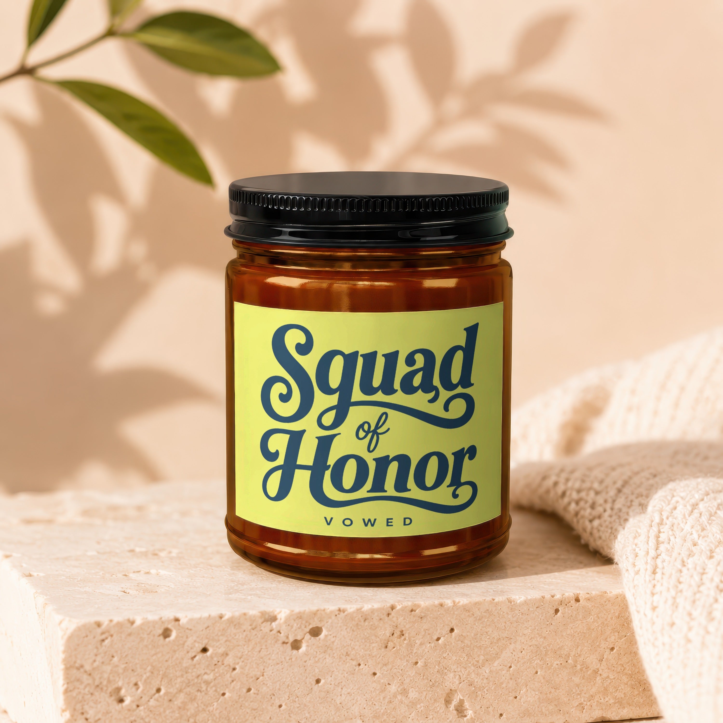 Candle with navy text "Squad of Honor Vowed" on a yellow label.
