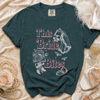 Dark teal shirt with "This Bride Bites" text and skull graphic.